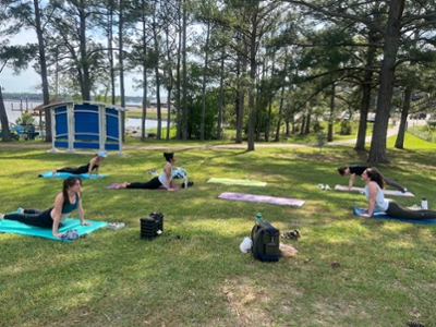 The Women in Emergency Medicine group practices yoga in the park.